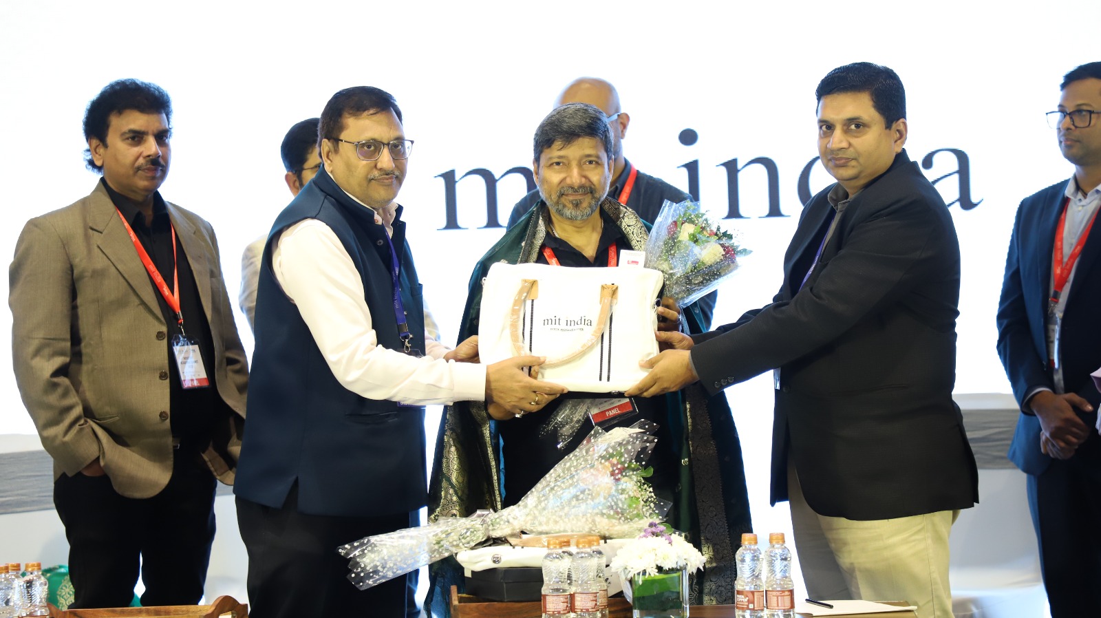 Alipta Ballav receiving recognition on stage at a professional event.